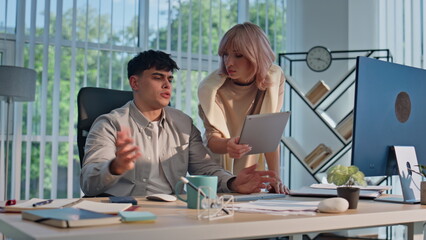 Fototapeta premium Young businessman working office agency closeup. Woman manager showing tablet