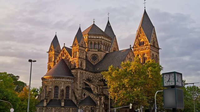 Herz-jesu-kirche catholic church during a picturesque sunset in downtown Koblenz, Germany with parallax tracking motion