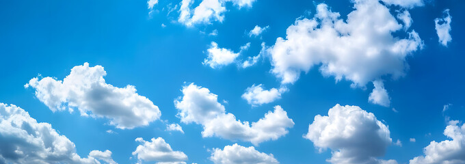 Blue sky with white clouds banner background, panoramic view, with space for text