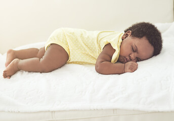 Home, sleeping and black baby with rest, calm and break with fatigue, growth and child development. African kid, apartment and infant with newborn, relax and bedroom with comfort and adorable