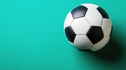 Naklejka premium Isolated soccer ball on a vivid green background, top-down perspective, perfect focus, no people