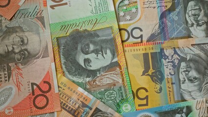Australian money featuring colorful banknotes including twenty, fifty, and other denominations, showcasing intricate designs and prominent figures.