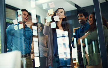 Collaboration, sticky notes and writing with business people in office together for brainstorming....