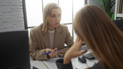 Women discussing business ideas in a modern office setting, highlighting their professional roles...