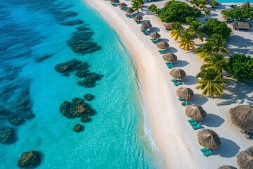 Fototapeta premium Beautiful tropical beach with straw umbrellas and crystal clear water in a sunny destination