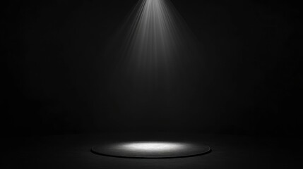 Spotlight on empty circular stage in dark room.