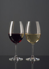Elegant display of red and white wine glasses set against a dark background