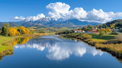 Obraz premium Autumnal river reflecting mountains, village; idyllic landscape