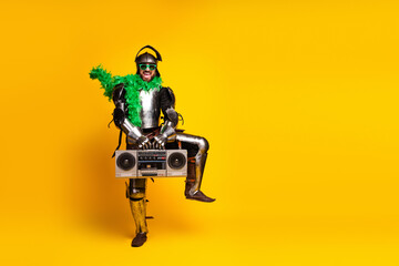 Knight in green boa with boombox standing on yellow background