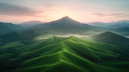 Fototapeta premium Aerial view of rolling green hills at sunrise, mountains in background. Possible use for nature and travel photography