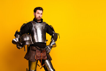 Portrait of a man in medieval armor with a vibrant yellow background and a confident pose
