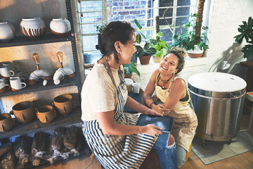Small business, workshop and women with tablet at pottery shop on social media for customer reviews. People, partners and team at startup on web for online post, blog engagement or ratings for art