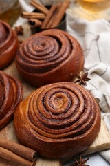 Delicious cinnamon roll buns on table, closeup