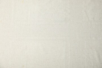Texture of beige tablecloth as background, top view