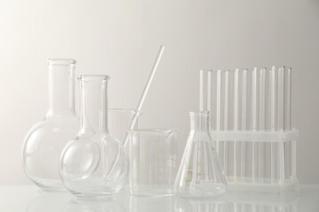 Many different laboratory glassware on light background
