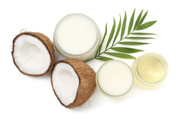 Cooking oils in glass jars, halves of coconut and green branch isolated on white, top view