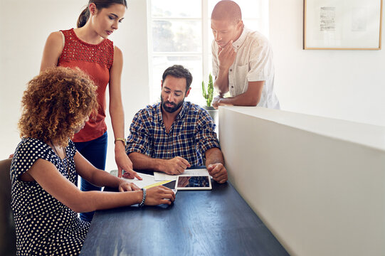 Graphic designers, tablet and people in startup for brainstorming, development and collaboration. Ideas, strategy and creative strategist in workplace for project, planning or teamwork in meeting - Powered by Adobe