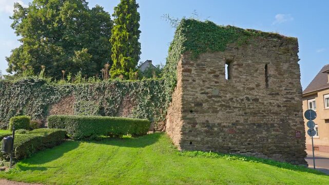 Remains of a Medieval European stone wall enterance on a sunny summer day with parallax tracking movement, Rhine Valley, Germany