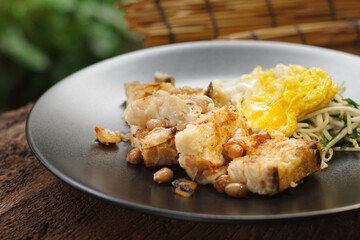 Fried Turnip Cake on wooden table. Traditional Chinese food. Fried Carrot Cake or local call name 