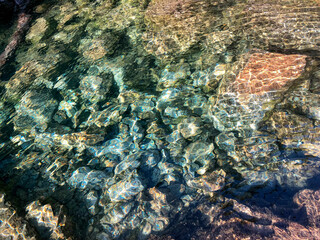 Crystalline Shallow Water with Colorful Rocks – San Martín de los Andes
