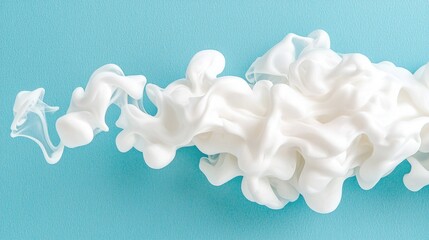 White ink swirling in blue water; abstract background