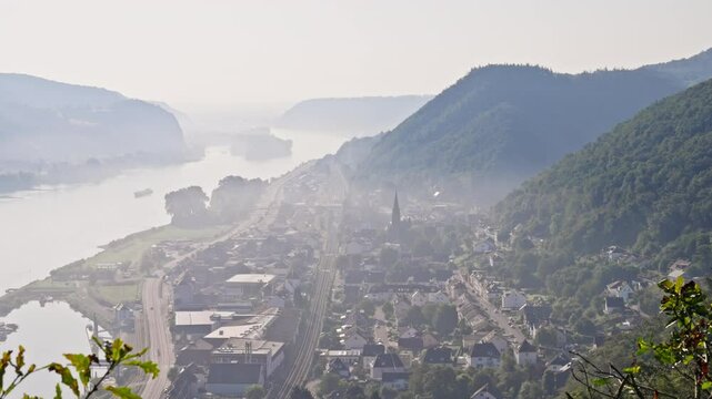 Scenic viewpoint sunrise over misty panoramic valley town along the Rhine River Valley, Germany
