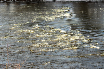 Shallow waterfalls in the river during the winter.