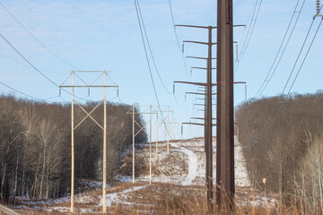 A high-voltage power line corridor cresting a hill in the Upper Peninsula of Michigan during the...