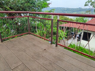 Fototapeta premium CONSTRUCTION OF AN IRON AND WOODEN STAIR VIEWPOINT WHICH IS AN ATTRACTION FOR TOURISTS TO ENJOY THE VIEW