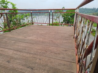 Fototapeta premium CONSTRUCTION OF AN IRON AND WOODEN STAIR VIEWPOINT WHICH IS AN ATTRACTION FOR TOURISTS TO ENJOY THE VIEW
