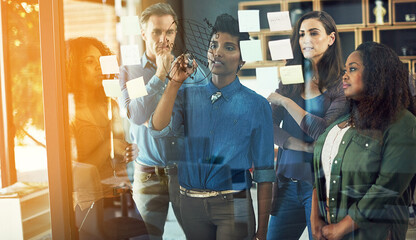 Woman, team and glass wall with writing at office, startup or review for stats, charts or budget in meeting. Business people, presentation and notes on board, planning and graphs for revenue at job