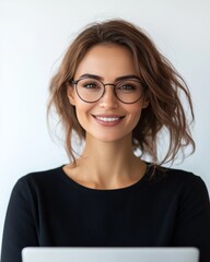 Fototapeta premium Smiling woman with glasses and laptop, representing confidence and modern lifestyle.