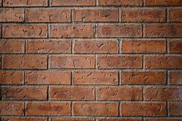Dark red brick wall, closeup.