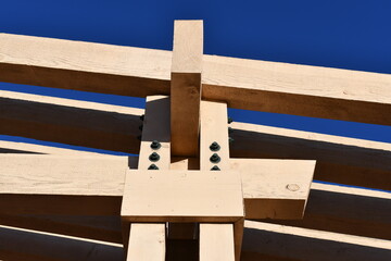 Wooden beams joined together by steel bolts.