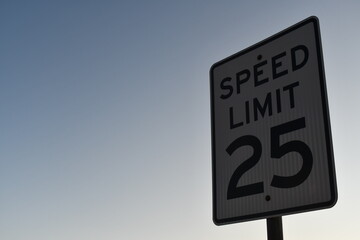 Speed limit 25 sign. Twilight sun from behind.