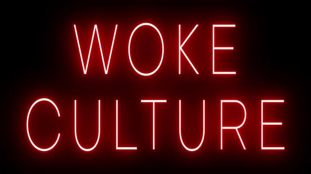 Flickering red retro style neon sign glowing against a black background for WOKE CULTURE