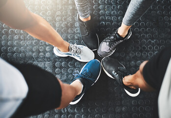 Fitness, group or gym with shoes in circle for teamwork, workout or unity at indoor health club....