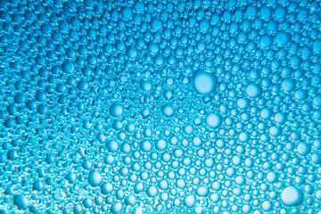 Texture of soap bubbles and water with blue light