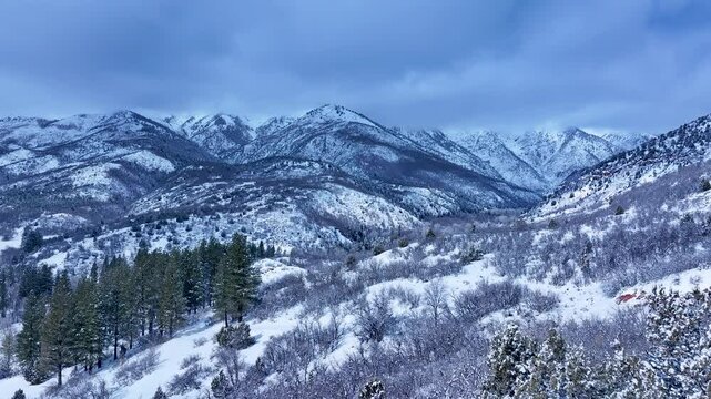 Aerial Mount Nebo Utah winter snow mountain valley 2. Beautiful late winter Wasatch Mountains. Valley and alpine landscape. Cold weather cloud environment. Rocky ledges, cliffs, canyon and valleys. 