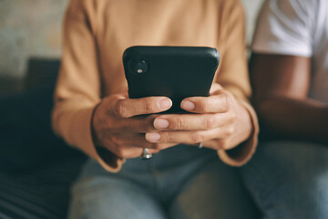 Hands, typing and phone with woman on sofa for social media update, networking and streaming reel. Post notification, viral news and communication with closeup of person in living room at home