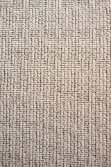 Textured woven fabric with a grid-like pattern in neutral tones. The interwoven fibers create a...