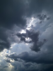 Fototapeta premium Sun Rays Through Storm Clouds, Dramatic Sky, Hopeful Sunlight Image