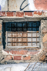 A closed basement window on a winter day