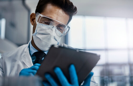 Reading, medical research and man with tablet, lab and info for medicine, pharmaceutical or scientist. Clinic, PPE and online for drugs with side effects, healthcare and person with tech for analysis