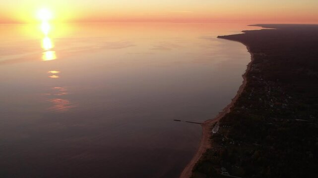 Tranquil Sunset Over a Calm Coastal Shoreline with Reflective Waters. Latvia. Tuja village
