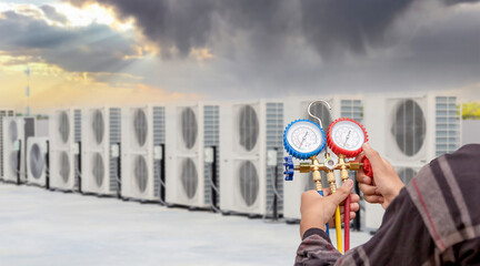 Air conditioner technician checking air conditioner operation	