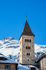 Fototapeta premium Church tower of the Church of the Sacred Heart in Samedan in the canton of Graubünden, Switzerland.