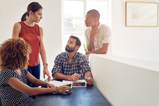 Graphic designers, tablet and people in discussion for brainstorming, development and collaboration. Ideas, strategy and creative strategist in startup for project, planning or teamwork in meeting