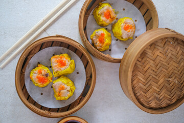 Delicious Steamed Siomay Dumplings Presented In Bamboo Baskets Alongside Chili Sauce, Offering A Warm, Savory, And Authentic Asian Meal.