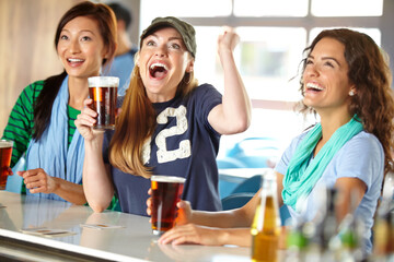 Excited, beer and women in pub with cheers, game goal and sports for support together. Celebration, happy hour and group of friends with alcohol, drink and broadcast television for team match in bar